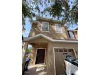 Charming two-story home with a welcoming front entrance and attached garage at 10402 Tulip Field Way, Riverview, FL 33578