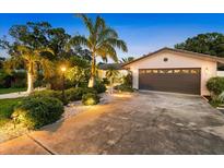 Charming single-story home featuring mature landscaping and a spacious driveway at 10515 Hetrick W Cir, Largo, FL 33774