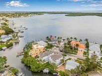 Waterfront property featuring tropical landscaping, boat docks, and stunning views of the bay at 1819 Bayou Grande Ne Blvd, St Petersburg, FL 33703