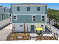 Inviting two-story home with charming patio, yellow umbrella and manicured landscaping at 3101 4Th N Ter, St Petersburg, FL 33713
