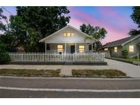 Charming home with a white picket fence, manicured lawn, and welcoming front porch at 3806 N Tampa St, Tampa, FL 33603