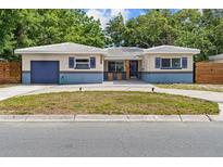 Charming single-story home with blue accents, a well-manicured lawn, and a private garage at 5826 20Th S Ave, Gulfport, FL 33707