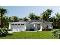 Beautiful one-story home with a two car garage, complemented by lush landscaping and stately palms at 6 Simonton Ave, North Port, FL 34286