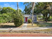 Charming single-story home with a red front door and well-maintained landscaping at 601 Newton S Ave, St Petersburg, FL 33701
