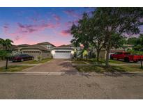 Charming single-story home featuring a brick driveway, two car garage, and well-maintained landscaping at 8407 Hunters Fork Loop, Ruskin, FL 33573