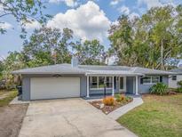 Charming single-story home with a well-manicured lawn and an attached two-car garage at 949 Virginia St, Dunedin, FL 34698