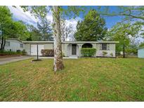 Charming single-story home featuring a well-maintained lawn and inviting front entrance at 9613 River Rd, Spring Hill, FL 34608