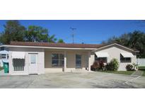 Charming single-story home with ample parking, awnings, and well-maintained landscaping at 10701 Village Green Ave, Seminole, FL 33772