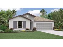 Charming single-Gathering home with a two-car garage, manicured lawn, and lush landscaping at 118 Leisure Pl, Rotonda West, FL 33947