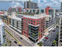 Multi-story condo building with glass balconies located in an urban setting with palm trees and street views at 1208 E Kennedy Blvd # 914, Tampa, FL 33602