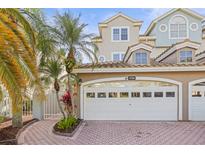 Charming home featuring a two-car garage, well-maintained landscaping, and a beautiful brick driveway at 1768 Lago Vista Blvd, Palm Harbor, FL 34685