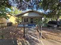 Charming bungalow with a cozy front porch and gated yard, ready for your personal touch at 3503 N 11Th St, Tampa, FL 33605