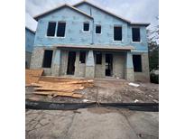 Two-story exterior showing a newly constructed home with blue weather-resistant barrier ready for siding at 406 N Westland St # 1, Tampa, FL 33609