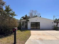 Charming single-story home featuring a well-maintained lawn and a classic, inviting facade at 4322 Baden Dr, Holiday, FL 34691