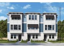 Modern townhome featuring a stylish exterior with clean lines, neutral colors, and black window accents at 6605 N Nebraska Ave # 6, Tampa, FL 33604