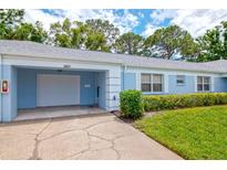 Charming single-story home with a one-car garage, blue paint, and well-maintained landscaping at 8064 Brentwood Rd, Seminole, FL 33777