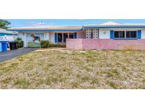 Single-story home featuring a front yard with a painting on the garage door at 1301 62Nd S Ter, St Petersburg, FL 33705