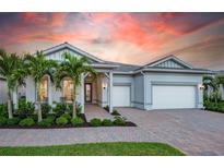 Charming single-Gathering home with a three-car garage, beautiful landscaping, and a brick-paved driveway at 14727 Eagle Branch Dr, Nokomis, FL 34275