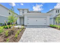 Charming two-story home with a two-car garage and well-manicured front yard at 15853 Elina Sky Dr, Punta Gorda, FL 33982