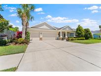 Charming single-story home with a three-car garage and well-manicured landscaping at 17731 Bright Wheat Dr, Lithia, FL 33547