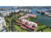 Beautiful aerial view of waterfront condos with boat docks and lush landscaping in desirable location at 7867 Sailboat Key S Blvd # 101, South Pasadena, FL 33707