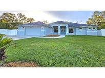 Beautiful single-story home with a well-manicured lawn and attached two-car garage at 11240 Marvelwood, Brooksville, FL 34614