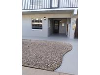 Charming condo featuring a rock garden and front entry with a mailbox and porch lighting at 1415 Doolittle Ln # 104, Dunedin, FL 34698