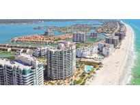 Stunning aerial view of beachfront condos and coastal waterways of Sand Key, Florida at 1560 Gulf Blvd # 306, Clearwater Beach, FL 33767