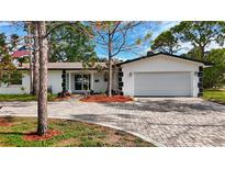 Charming single Gathering home featuring a paver driveway and a well-manicured front yard at 2001 Pinellas Point S Dr, St Petersburg, FL 33712