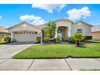 Charming single-Gathering home featuring a well-manicured lawn and inviting curb appeal at 25330 Conestoga Dr, Land O Lakes, FL 34639