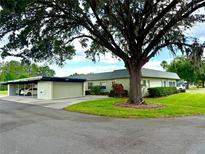 Charming home featuring mature landscaping and an attached carport at 3411 Teeside Dr, New Port Richey, FL 34655