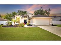 Charming single-Gathering home with a manicured lawn and attached two-car garage at 4302 Longfellow Dr, Plant City, FL 33566