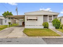 Charming single-story home featuring a covered carport, well-maintained lawn, and a welcoming front entrance at 4314 12Th Street E Ct, Ellenton, FL 34222
