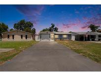 Charming single-story home with a well-maintained lawn, long driveway and inviting curb appeal at 5081 72Nd N Ave, Pinellas Park, FL 33781