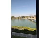 Scenic water view from window overlooking a bridge and lush greenery, inviting relaxation and tranquility at 7465 Bay Island S Dr # 312, South Pasadena, FL 33707