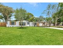 Charming single-story home with a well-manicured lawn and a covered carport, creating a welcoming curb appeal at 918 Skyview Dr, Brandon, FL 33510