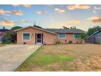 Charming single-story home featuring a well-maintained lawn and inviting curb appeal at 11665 Leisure W Ln, Largo, FL 33773