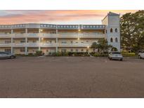 Lovely exterior of the condo building with unique tower feature and large parking lot at 2221 Swedish Dr # 55, Clearwater, FL 33763