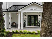 Charming front porch with stylish decor, brick accents, and a welcoming entrance at 3501 W Tacon St, Tampa, FL 33629
