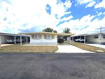 Charming single-story home with covered parking and manicured landscaping at 37135 Sandra Ave, Zephyrhills, FL 33542