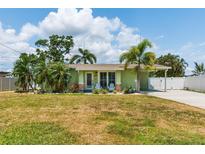 Charming single story home with a well maintained lawn, and a welcoming front porch with white chairs at 4681 Carson Ne St, St Petersburg, FL 33703