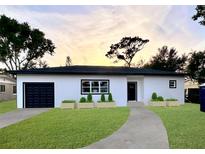 Beautifully renovated single-story home with a well-manicured lawn, black trim, and a one-car garage at 4920 72Nd N St, St Petersburg, FL 33709