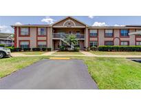 Inviting two-story condo showcasing well-maintained landscaping and convenient parking at 6428 Gloria Dr # 21, New Port Richey, FL 34653