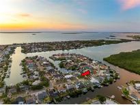 Gorgeous aerial view of the waterfront community showcasing its prime location and stunning sunset scenery at 6604 Dolphin Cove Dr, Apollo Beach, FL 33572