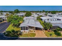 Charming home in a quiet community featuring well-maintained landscaping and an attached carport for convenient parking at 12501 Ulmerton Rd # 89, Largo, FL 33774