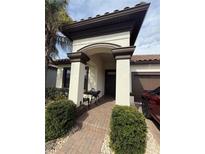 Charming home featuring a covered front entrance with brick pathway and manicured landscaping at 13172 Green Violet Dr, Riverview, FL 33579