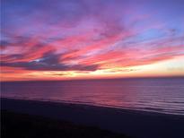 Beautiful sunset over the ocean with vibrant pink and orange colors reflecting on the water at 1390 Gulf Blvd # Ph-5, Clearwater, FL 33767
