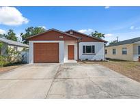 Charming single-story home with a well-maintained front yard, driveway, and a one-car garage at 4935 42Nd N Pl, St Petersburg, FL 33709
