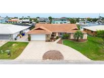 Charming single-story home featuring a beautiful terracotta roof and a spacious circular driveway at 5008 Southshore Dr, New Port Richey, FL 34652