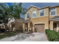 Charming two-story townhome with neutral stucco exterior, single car garage, and manicured front lawn in a quiet neighborhood at 6902 47Th N Ln, Pinellas Park, FL 33781